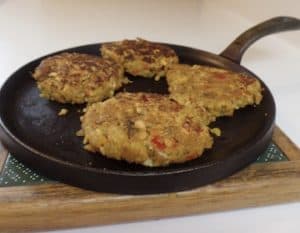 Four Cooked Veggie Patties on a frying pan